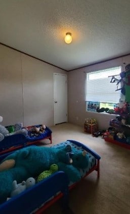 bedroom featuring a textured ceiling and light carpet