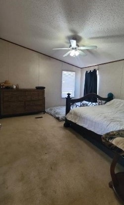 bedroom featuring a ceiling fan, a textured ceiling, and light colored carpet