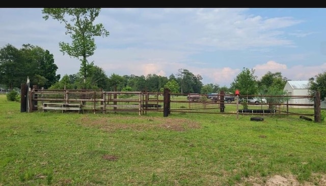 view of yard featuring a rural view and fence