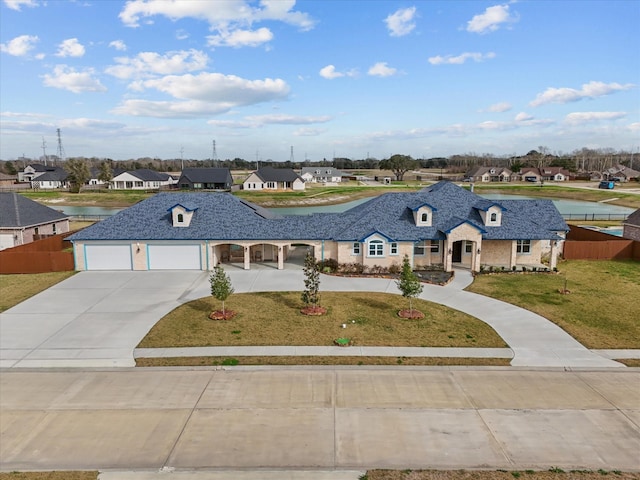 view of front facade featuring a front yard and a garage