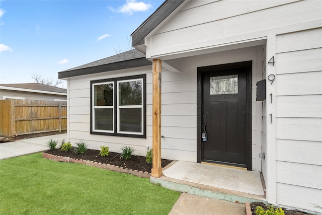 doorway to property featuring a yard