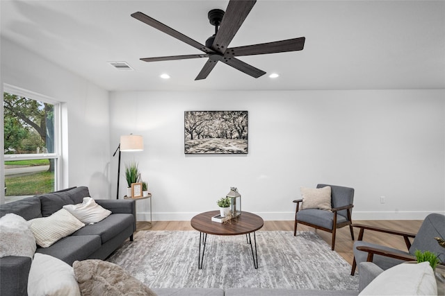 living room featuring light hardwood / wood-style floors and ceiling fan