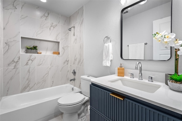 full bathroom featuring toilet, vanity, and tiled shower / bath