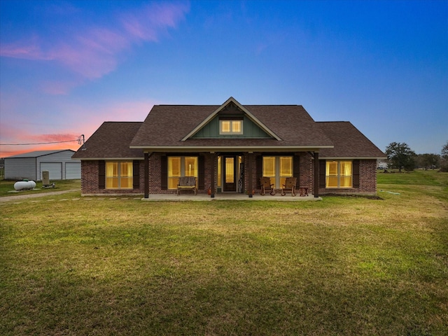 craftsman house with a lawn and a patio area