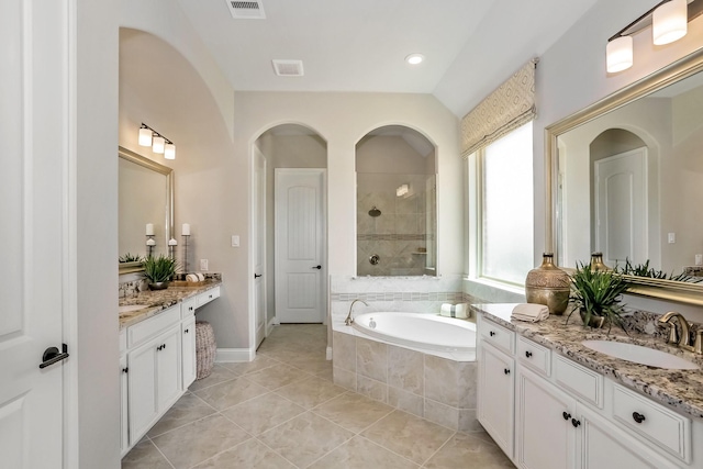 bathroom with tile patterned flooring, shower with separate bathtub, and vanity