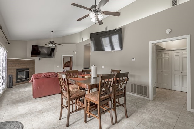 tiled dining room with high vaulted ceiling and ceiling fan