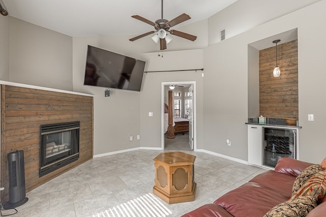 tiled living room featuring bar, high vaulted ceiling, ceiling fan, and beverage cooler