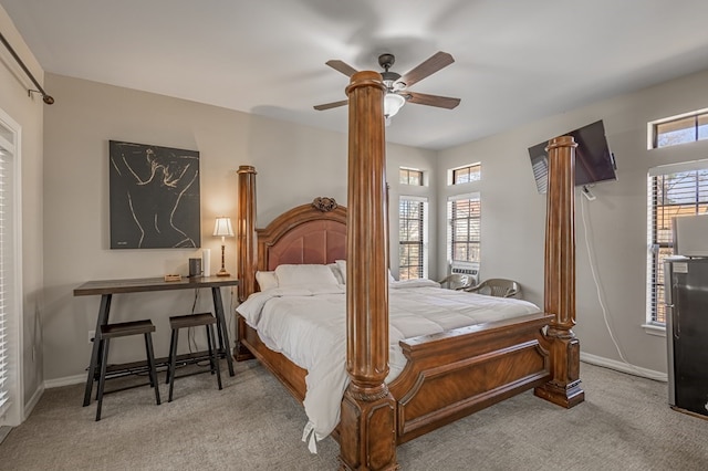 bedroom featuring light carpet, multiple windows, and ceiling fan