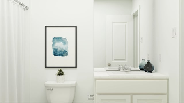 bathroom featuring toilet and vanity