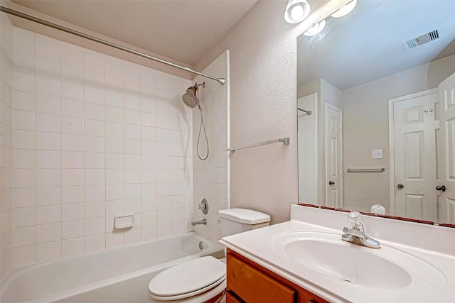 full bathroom featuring vanity, toilet, and tiled shower / bath