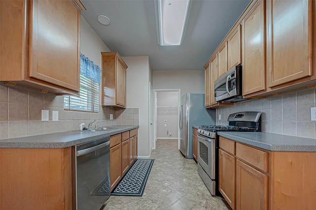 kitchen featuring sink, appliances with stainless steel finishes, light brown cabinets, and decorative backsplash