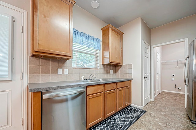 kitchen with sink, stainless steel appliances, and tasteful backsplash