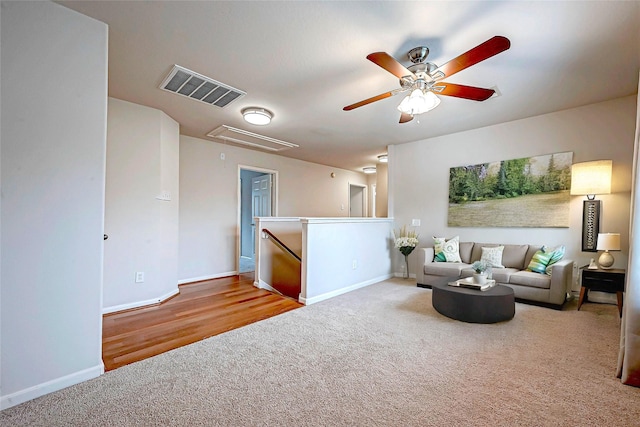 living room with ceiling fan and carpet floors