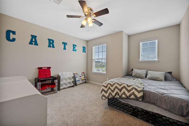 bedroom featuring a ceiling fan, light colored carpet, visible vents, and baseboards