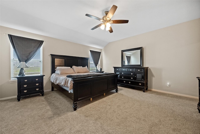 bedroom featuring baseboards, vaulted ceiling, a ceiling fan, and light colored carpet