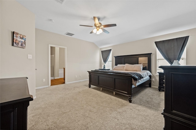 bedroom featuring light colored carpet, visible vents, vaulted ceiling, ceiling fan, and baseboards