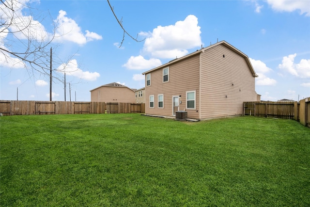 back of house with a yard, central AC unit, and a fenced backyard