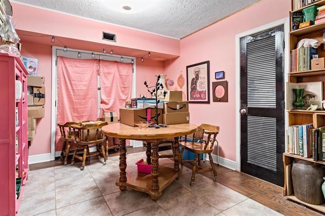 tiled dining room featuring a textured ceiling