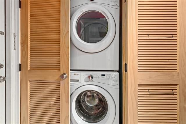 laundry room featuring stacked washer / drying machine