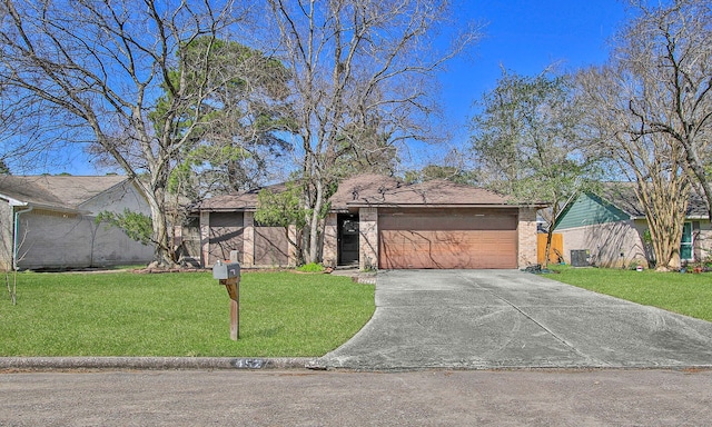 single story home with a front yard and a garage