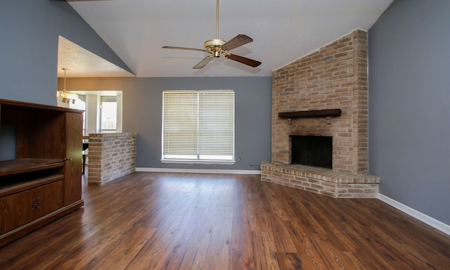 living room featuring a fireplace, dark hardwood / wood-style floors, ceiling fan with notable chandelier, and lofted ceiling