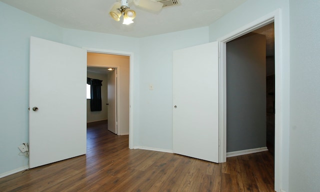 spare room with ceiling fan and dark hardwood / wood-style floors