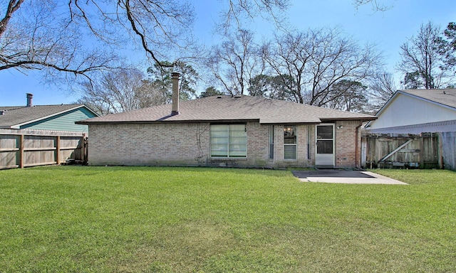 back of house with a lawn and a patio area