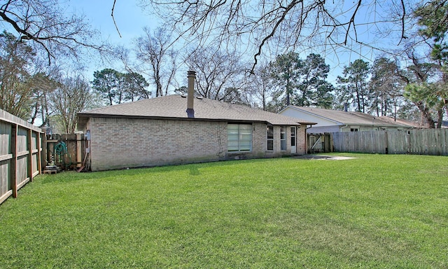 back of property featuring a yard