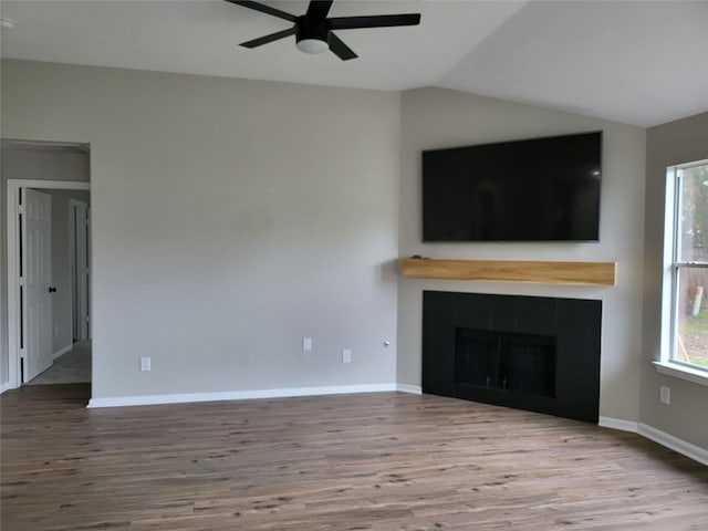 unfurnished living room with a fireplace, ceiling fan, light hardwood / wood-style floors, and lofted ceiling