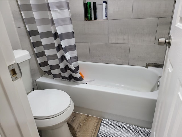 bathroom featuring shower / bath combination with curtain, toilet, and hardwood / wood-style floors