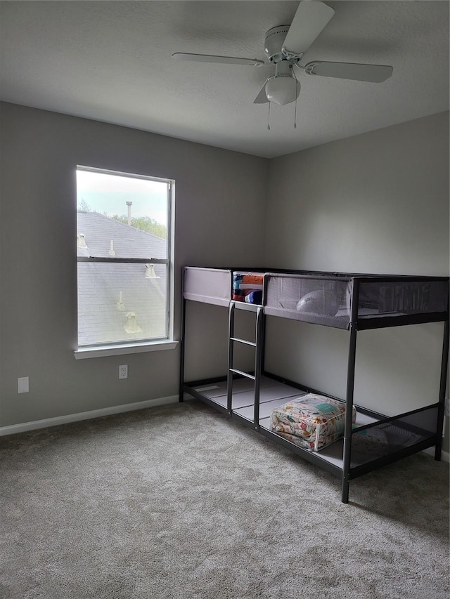 unfurnished bedroom with ceiling fan and carpet flooring