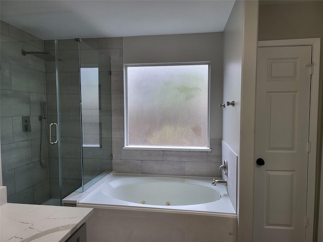 bathroom with vanity and independent shower and bath