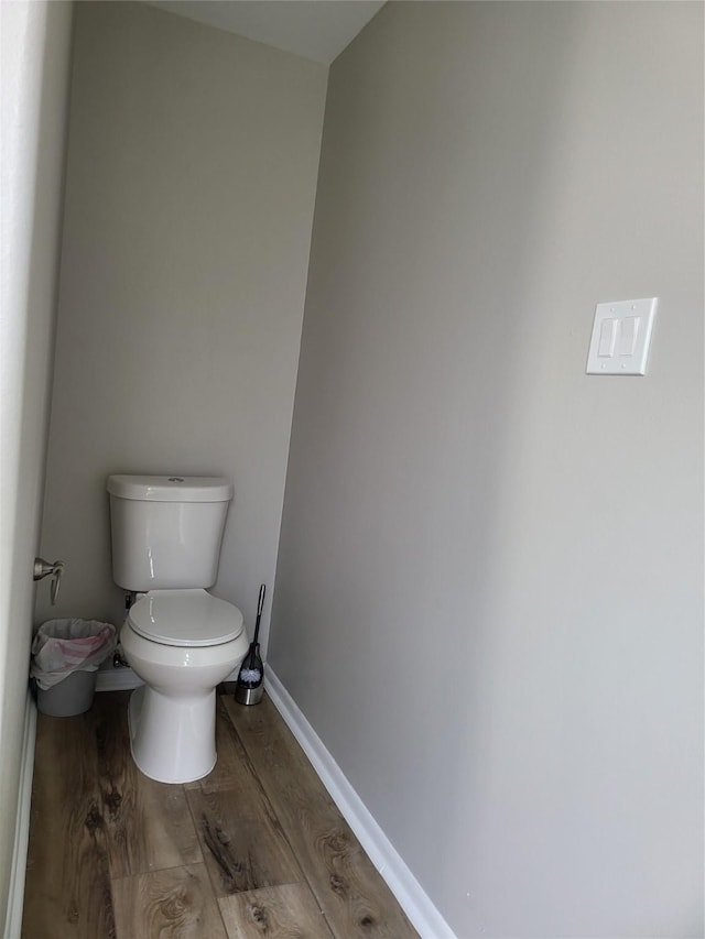 bathroom featuring hardwood / wood-style flooring and toilet