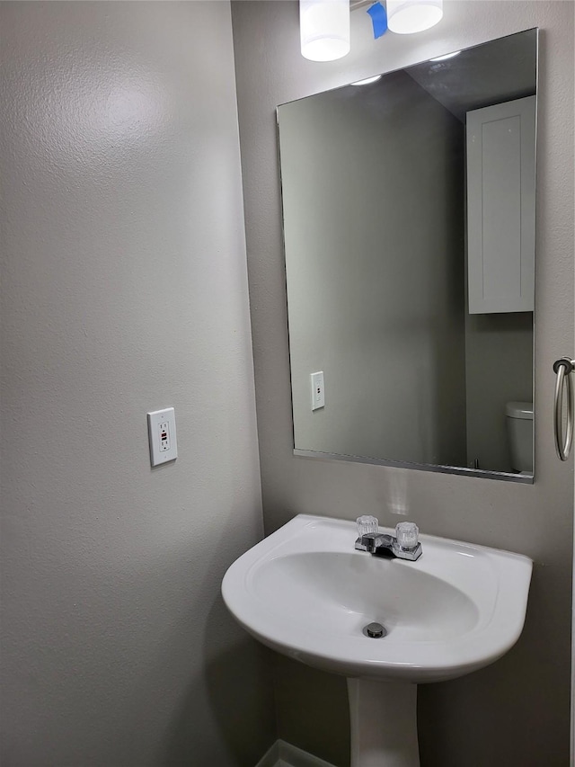 bathroom featuring sink and toilet