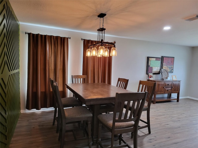 dining room featuring light hardwood / wood-style floors and an inviting chandelier