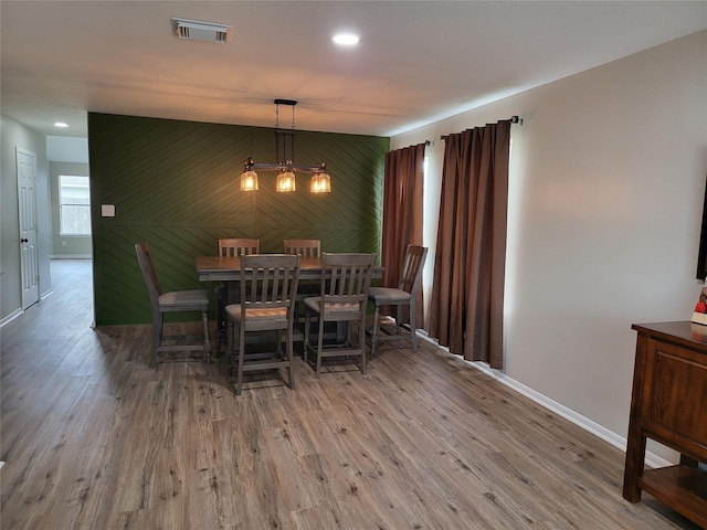 dining space featuring a chandelier and wood-type flooring