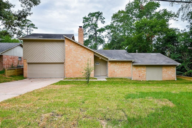 mid-century home with a garage, driveway, a chimney, a front yard, and brick siding