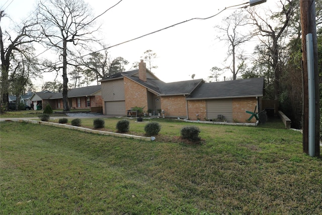 view of front of home with a front yard, brick siding, and a chimney