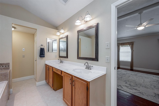 bathroom with a bath, tile patterned floors, vaulted ceiling, ceiling fan, and vanity