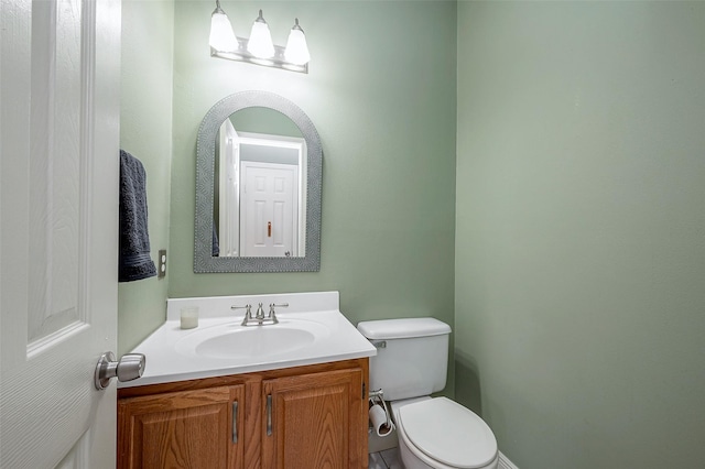 bathroom with toilet and vanity