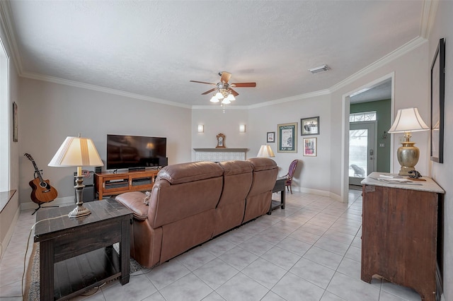 living room featuring a textured ceiling, ornamental molding, ceiling fan, and light tile patterned floors