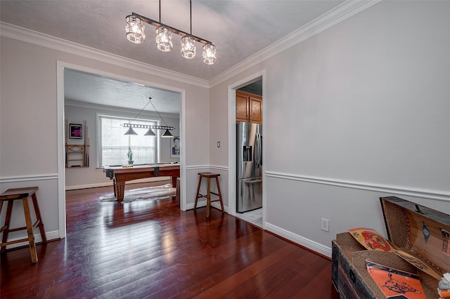 interior space featuring ornamental molding and dark hardwood / wood-style floors