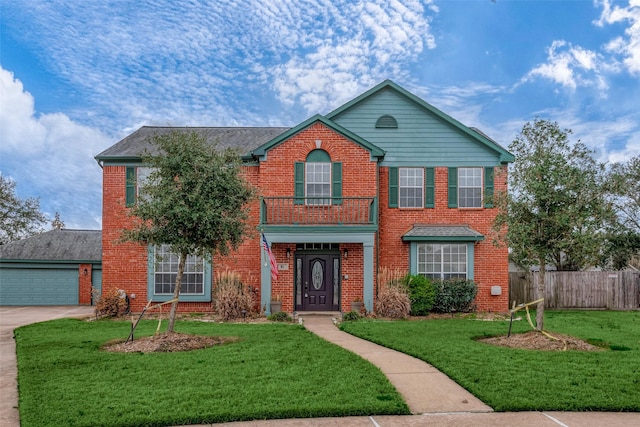 view of property featuring a front lawn, a garage, and a balcony