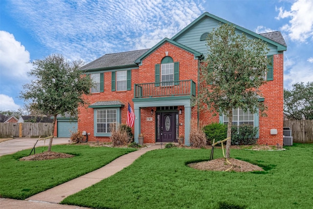 view of front facade with a front lawn, a garage, and a balcony