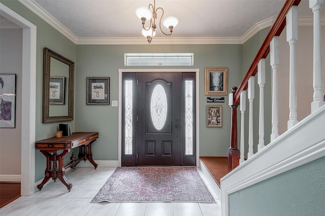 tiled foyer featuring crown molding and an inviting chandelier