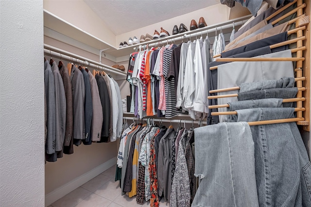 spacious closet featuring light tile patterned floors