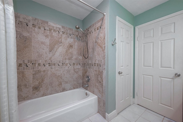 bathroom with tile patterned floors and shower / bath combo with shower curtain