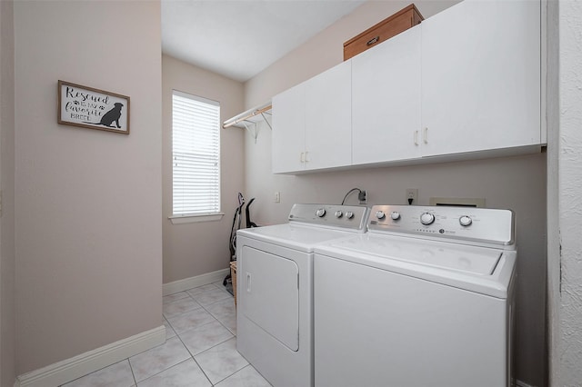 laundry area featuring cabinets, separate washer and dryer, and light tile patterned floors