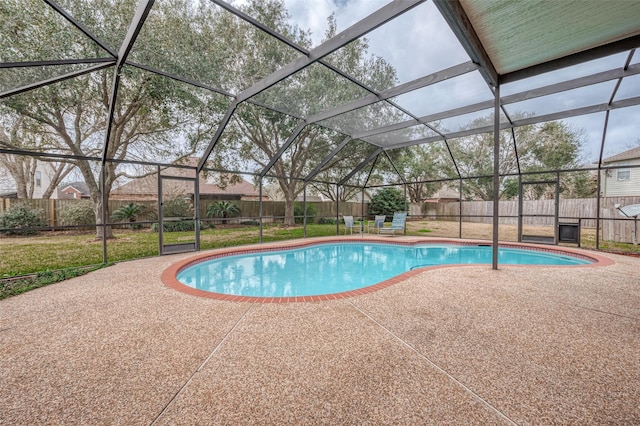 view of swimming pool featuring a patio area and glass enclosure