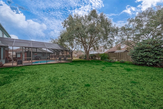 view of yard featuring a lanai, a fenced in pool, and a patio area